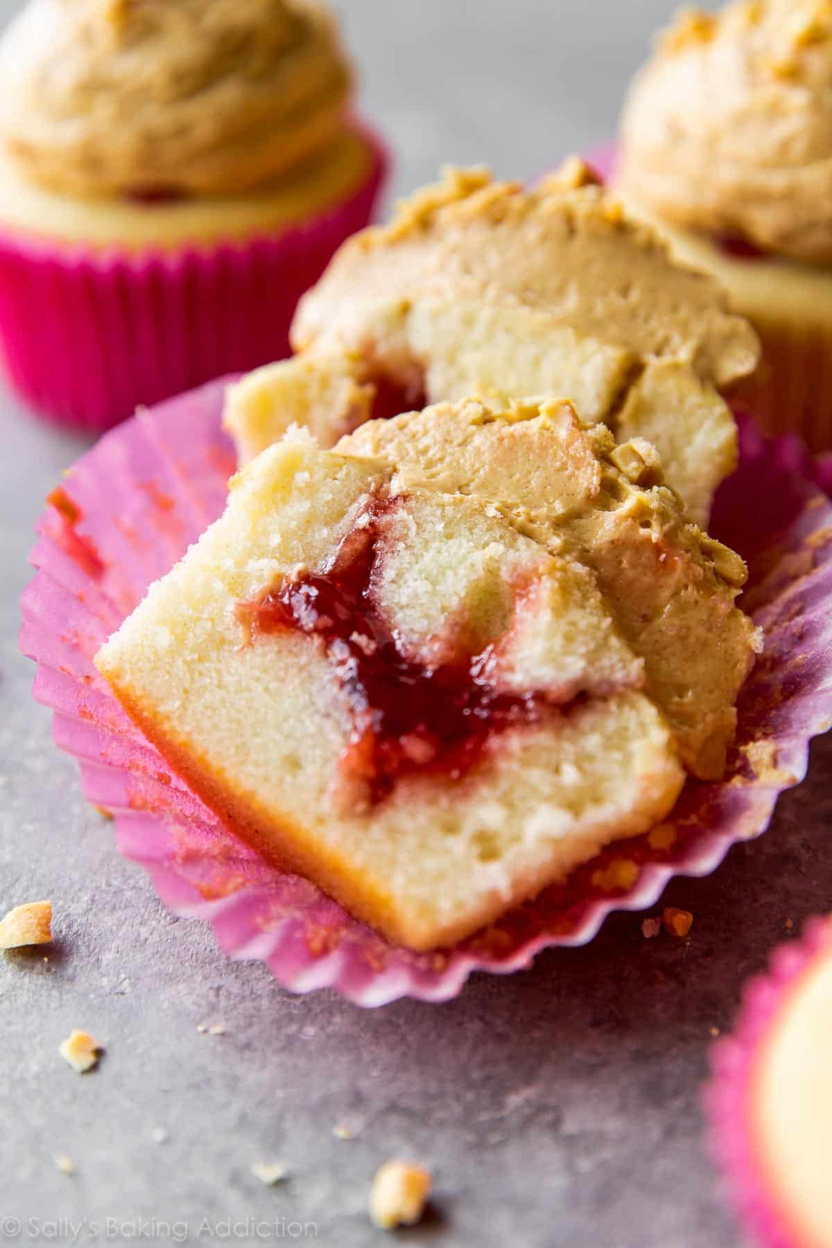 peanut butter and jelly cupcake cut in half showing jam filling