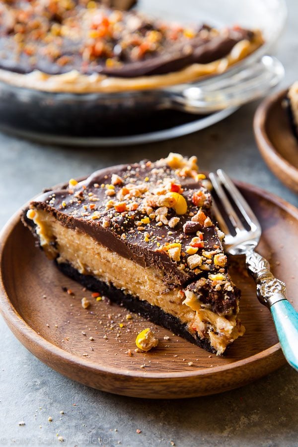 slice of peanut butter pie on a wood plate with a fork