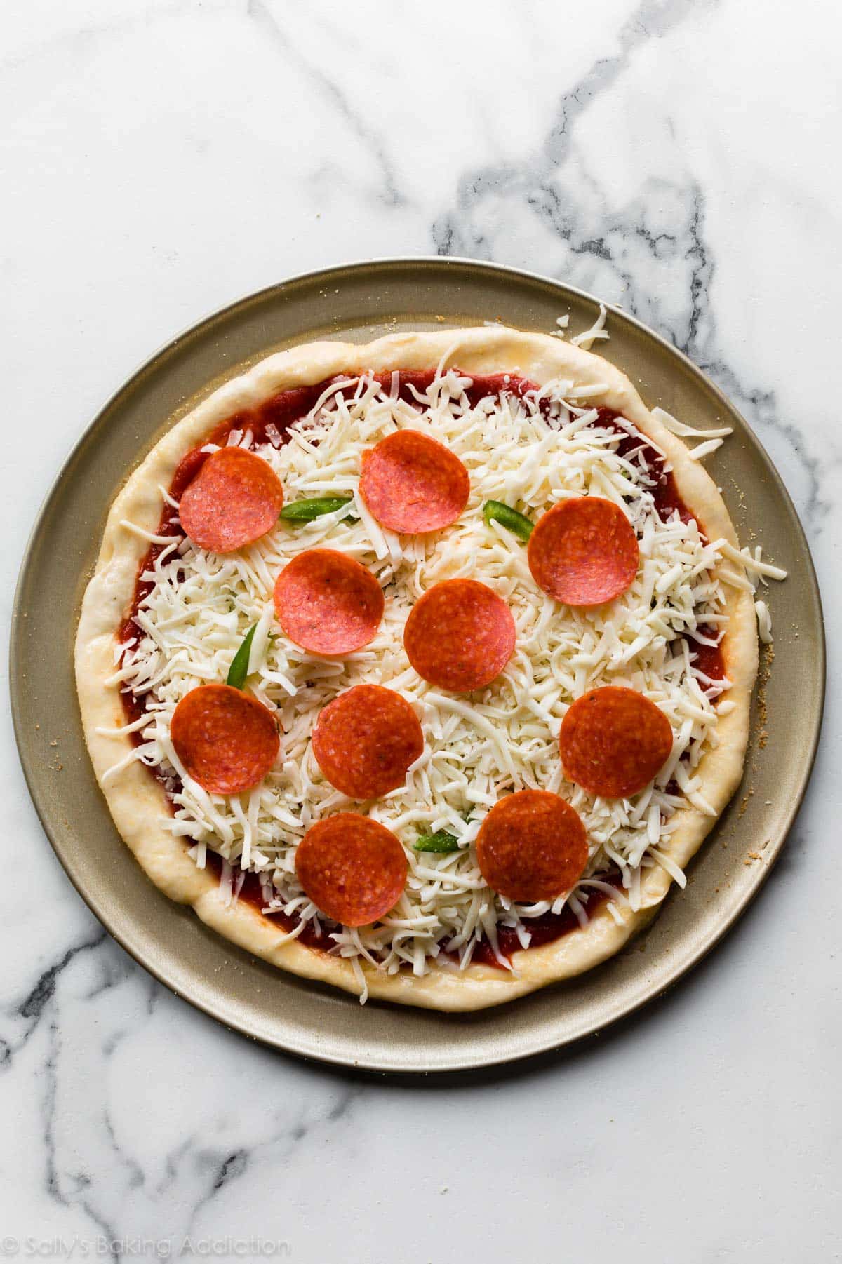 Pizza dough with toppings before baking