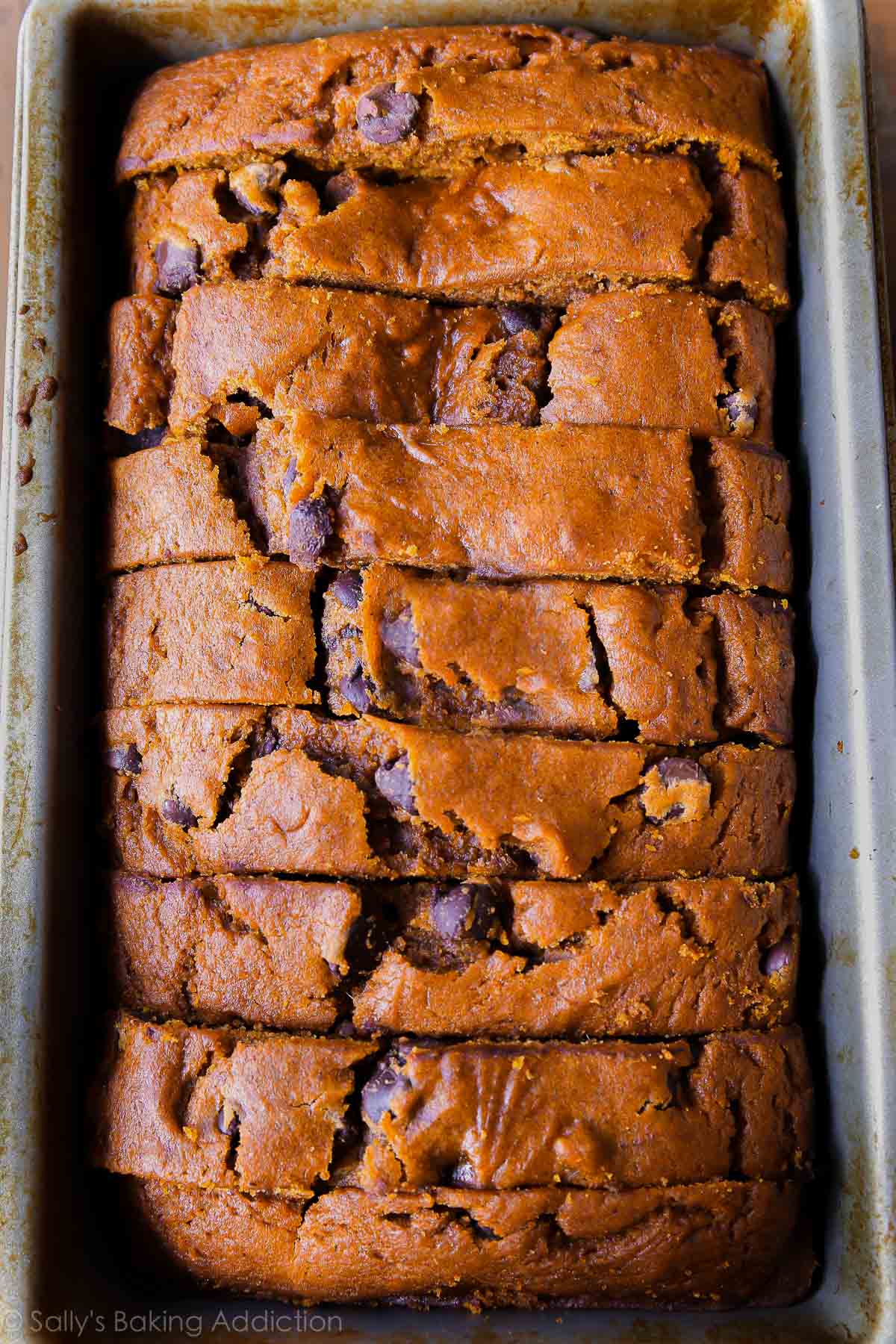 overhead image of sliced pumpkin chocolate chip bread in a loaf pan