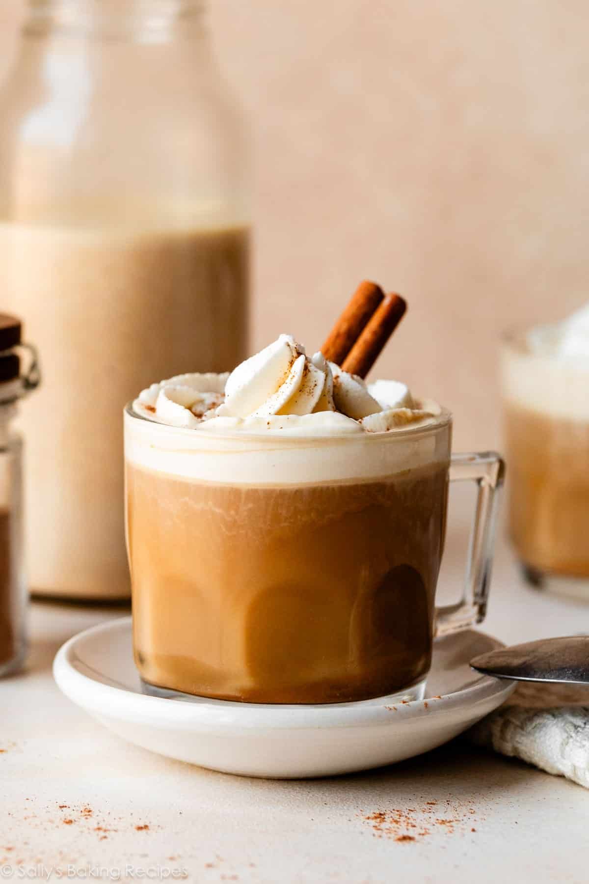 glass mug of pumpkin coffee creamer in coffee with whipped cream.