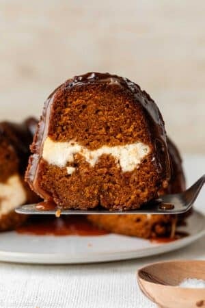 slice of pumpkin Bundt cake with cream cheese swirl inside.