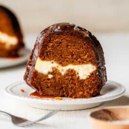 slice of pumpkin cheesecake Bundt cake on white plate.