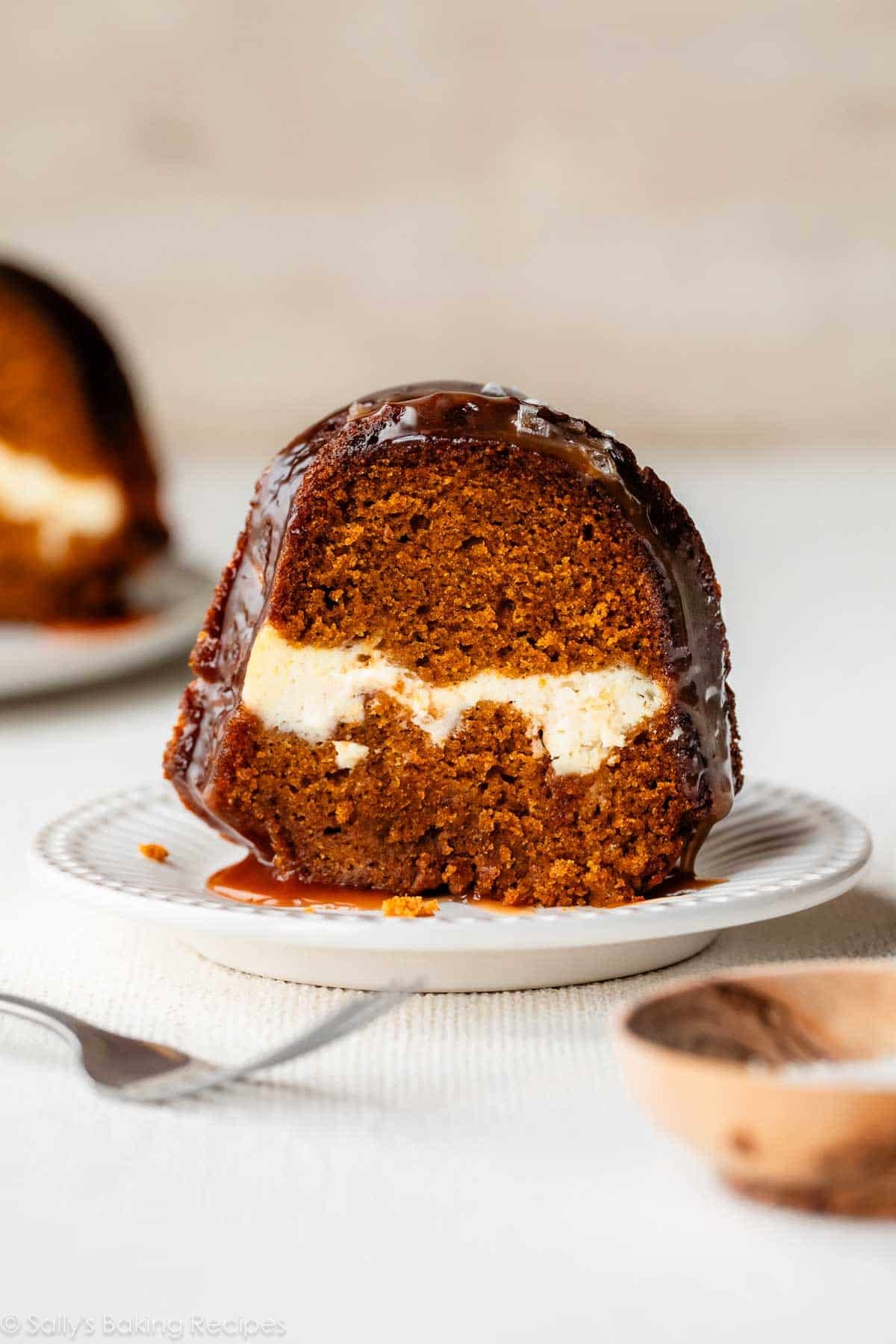 slice of pumpkin cheesecake Bundt cake on white plate.