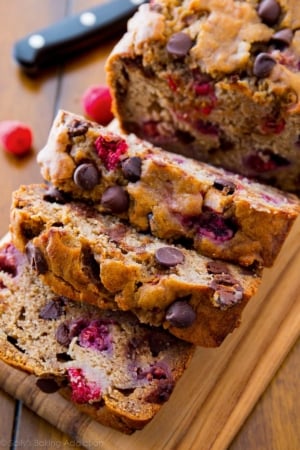 slices of raspberry dark chocolate banana bread on wood cutting board