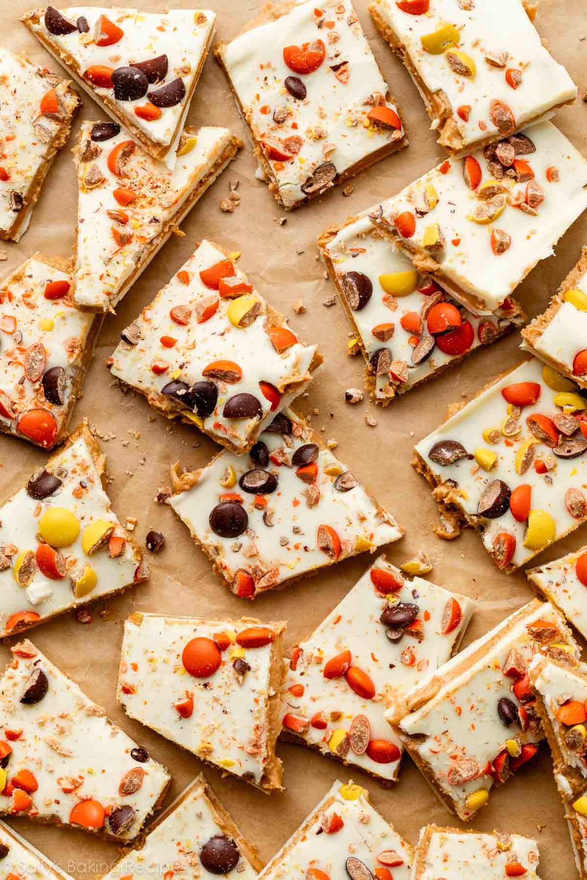 Reese's Pieces white chocolate peanut butter bark cut and broken into pieces.