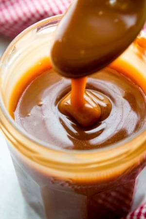 Salted caramel in a glass jar with a spoon