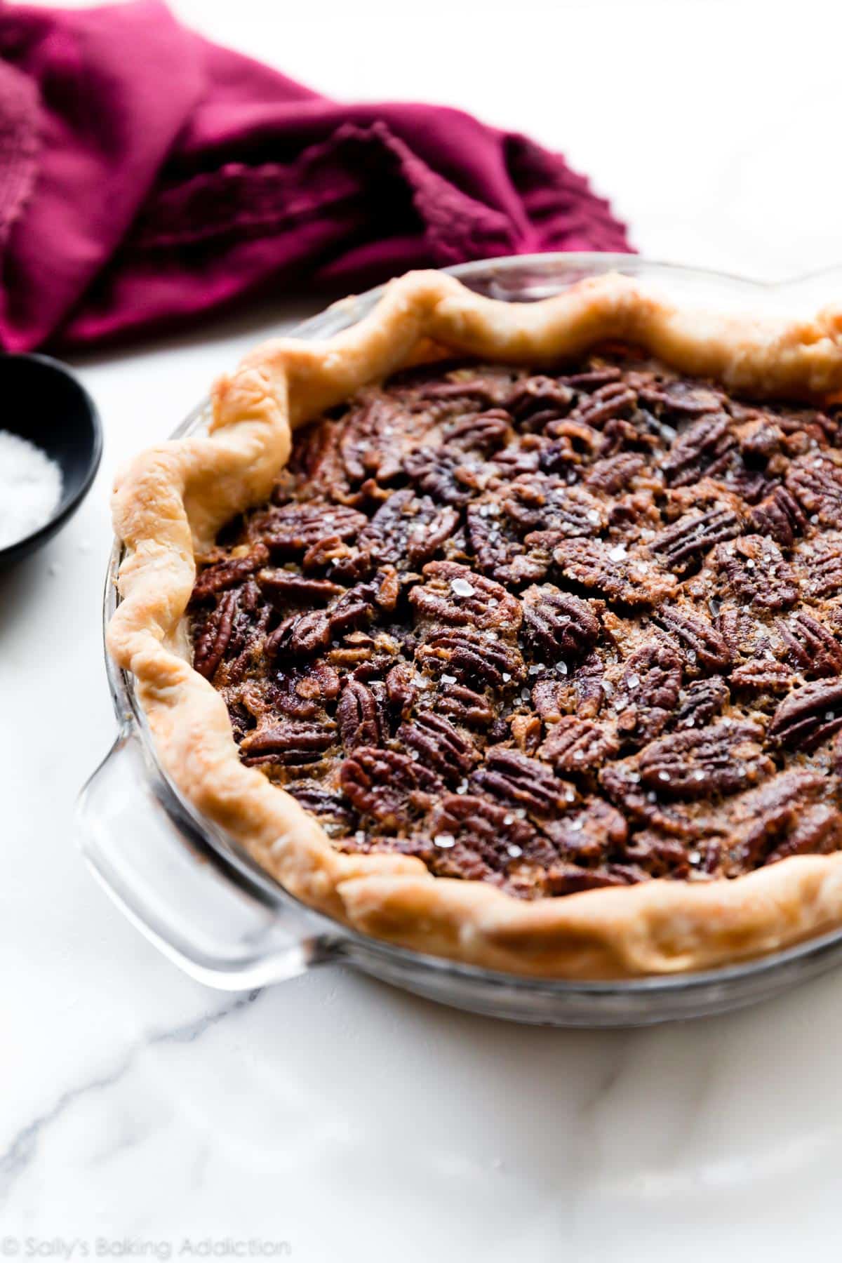 maple pecan pie in a glass pie dish