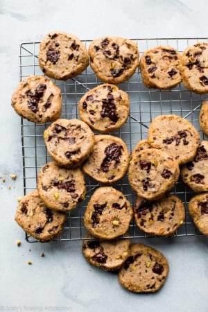 pistachio chocolate chunk cookies on a cooling rack