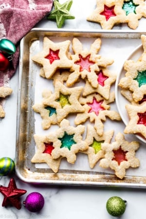 stained glass window cookies on baking sheet with decorative ornaments