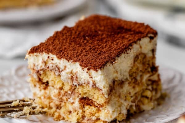 slices of tiramisu on white plates.