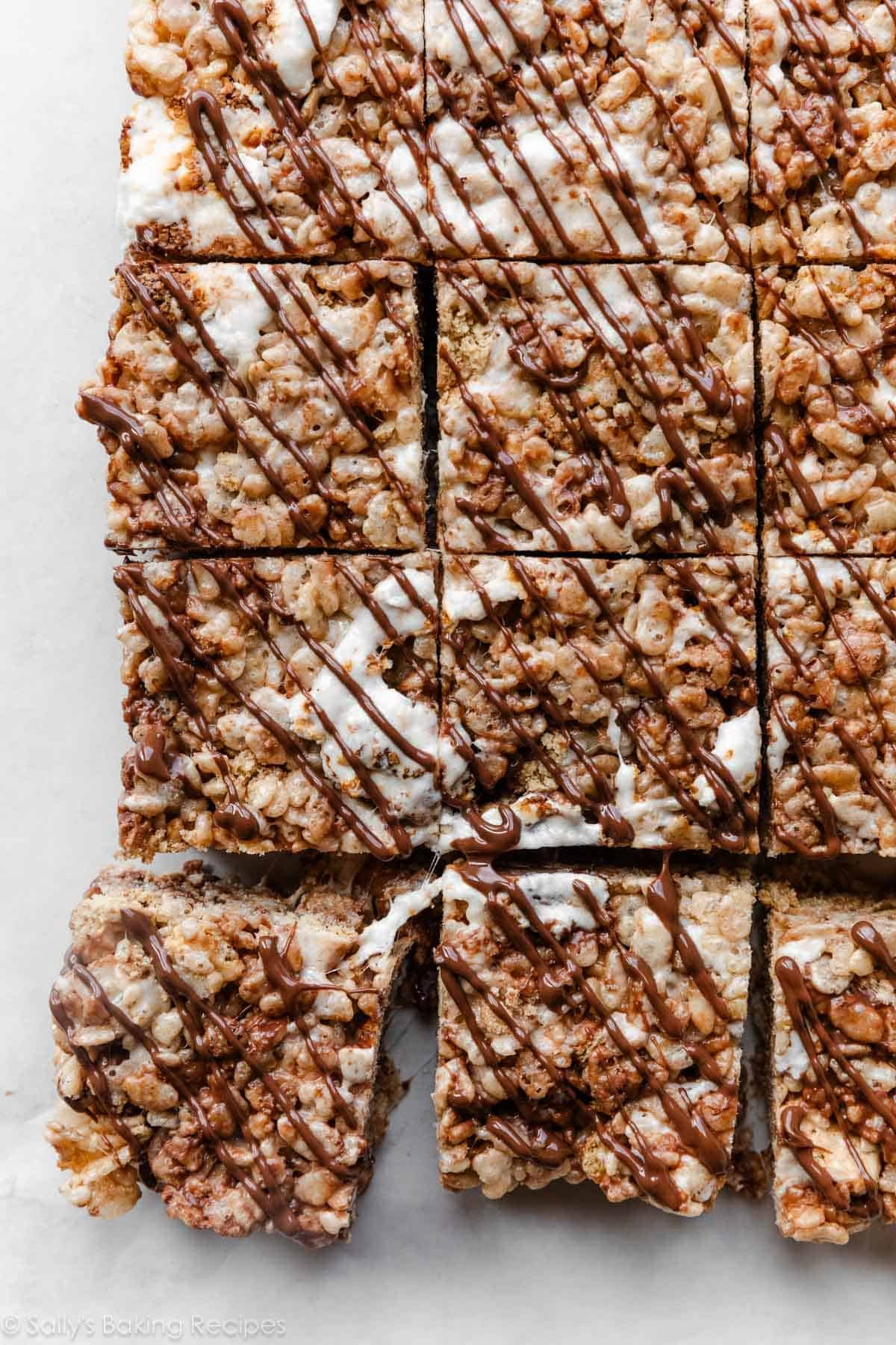 s'more rice krispie treats with toasted marshmallow and melted chocolate on top.