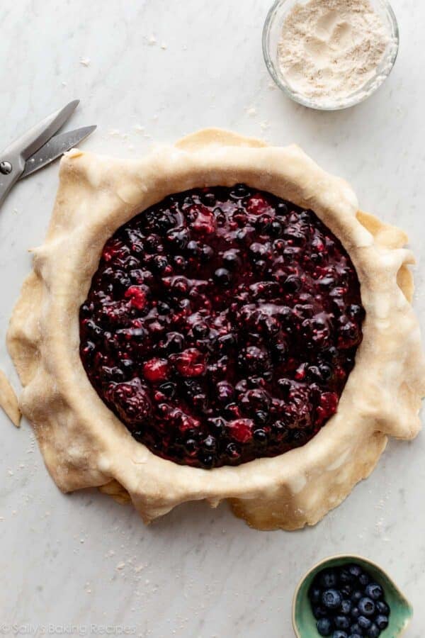 jammy berry pie filling in pie dough.