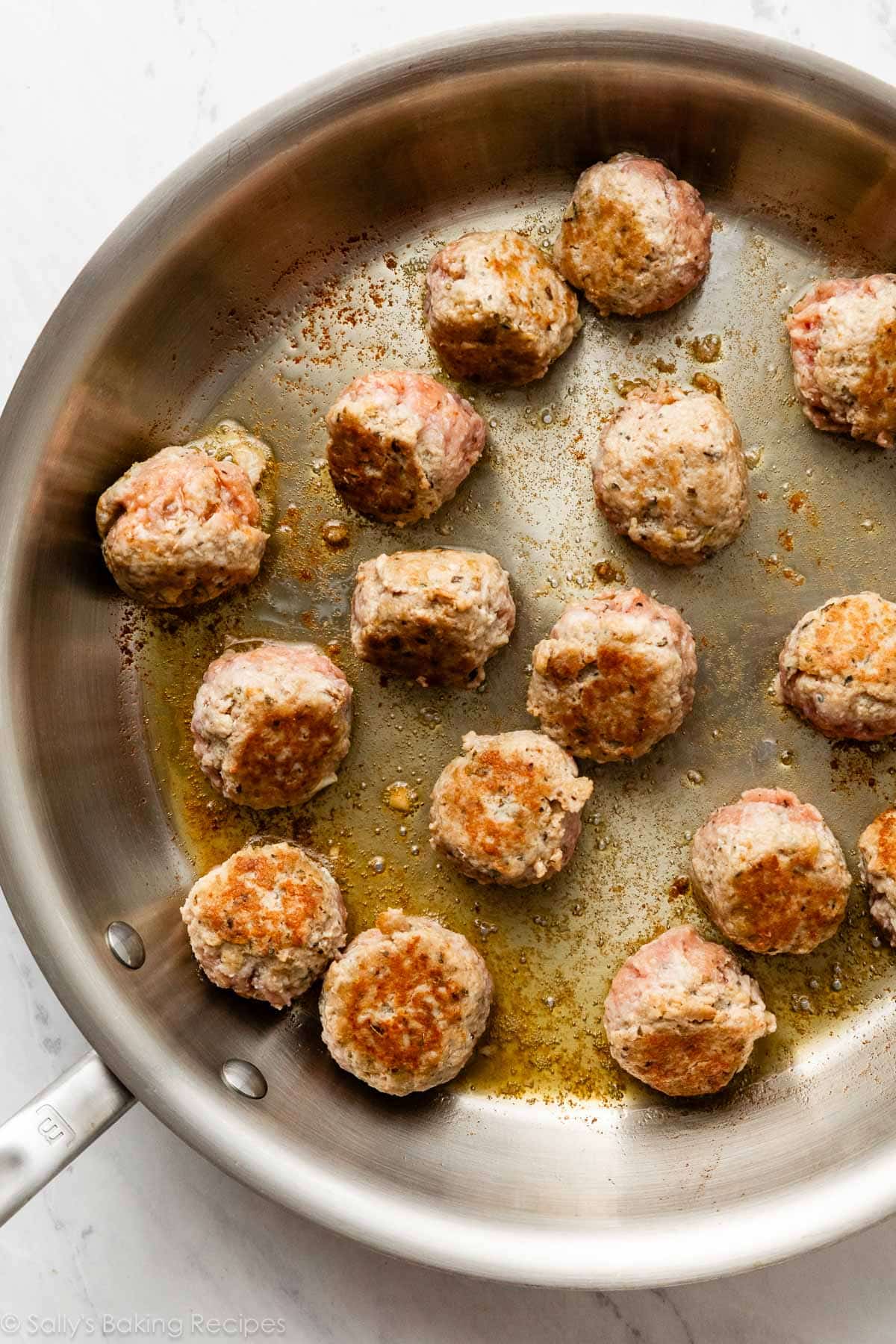 searing meatballs in skillet.