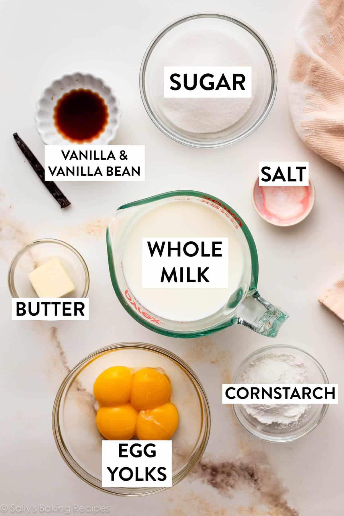 ingredients on counter including egg yolks, milk, sugar, butter, and vanilla.