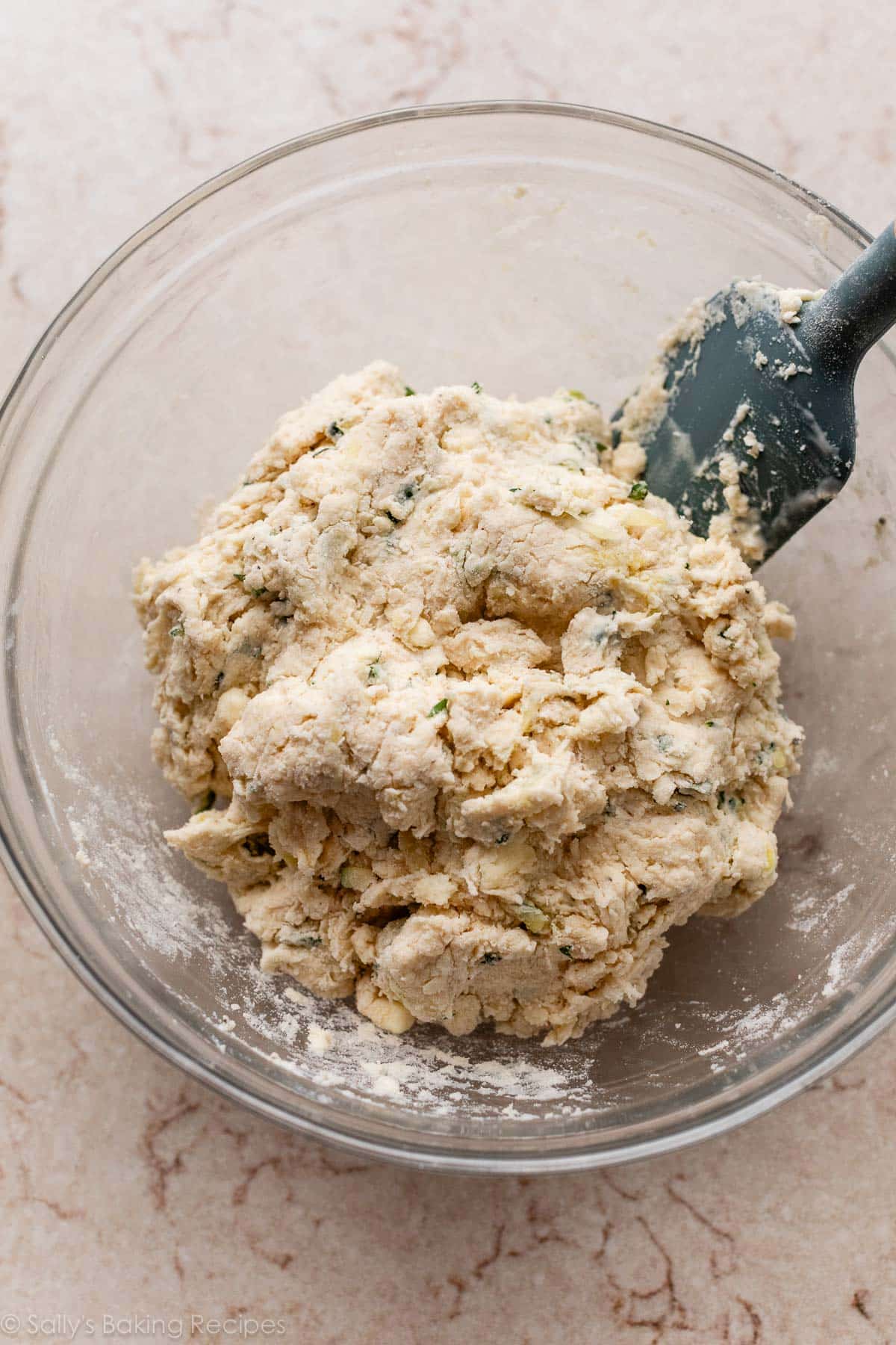 crumbly dough mixture in glass bowl.