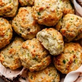 zucchini biscuits in pink linen-lined basket.